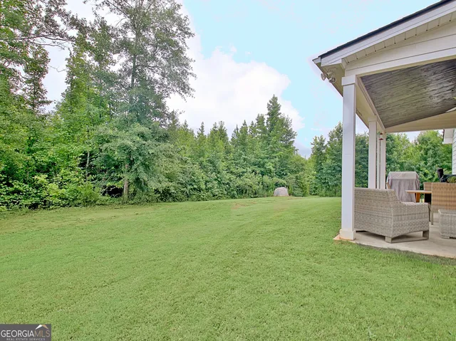 a view of a green field with lots of bushes
