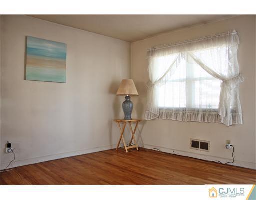 8 Wilshire Road Edison, NJ 08817 - Photo 14 of 25 a view of empty room with wooden floor and fan