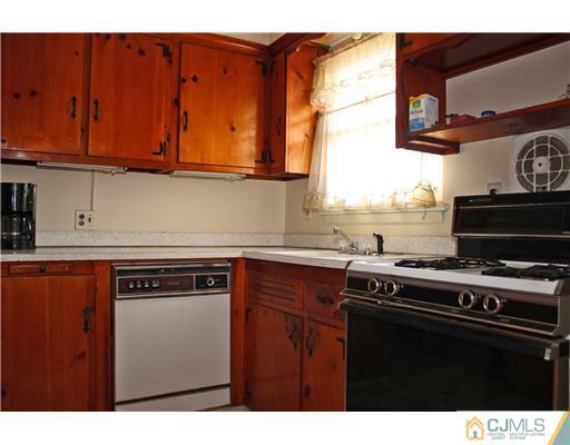 8 Wilshire Road Edison, NJ 08817 - Photo 4 of 25 a kitchen with stainless steel appliances a stove and a microwave
