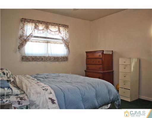8 Wilshire Road Edison, NJ 08817 - Photo 5 of 25 a bedroom with a bed and a window
