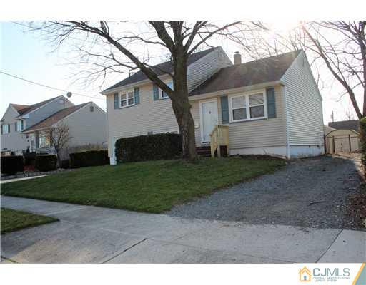 8 Wilshire Road Edison, NJ 08817 - Photo 10 of 25 a view of a white house next to a yard and large trees