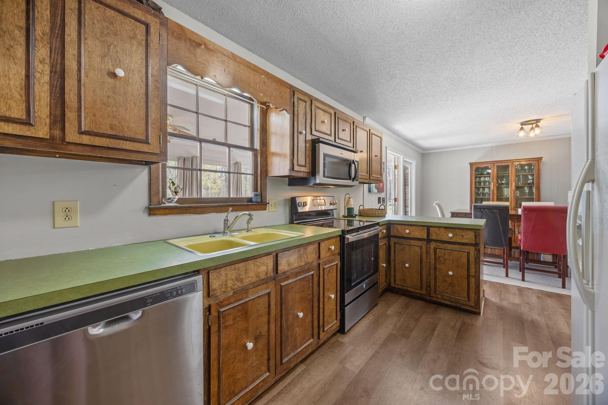 9698 Pine Tree Road, Unit 55 Norwood, NC 28128 - Photo 12 of 29 a kitchen with lots of counter top space and sink