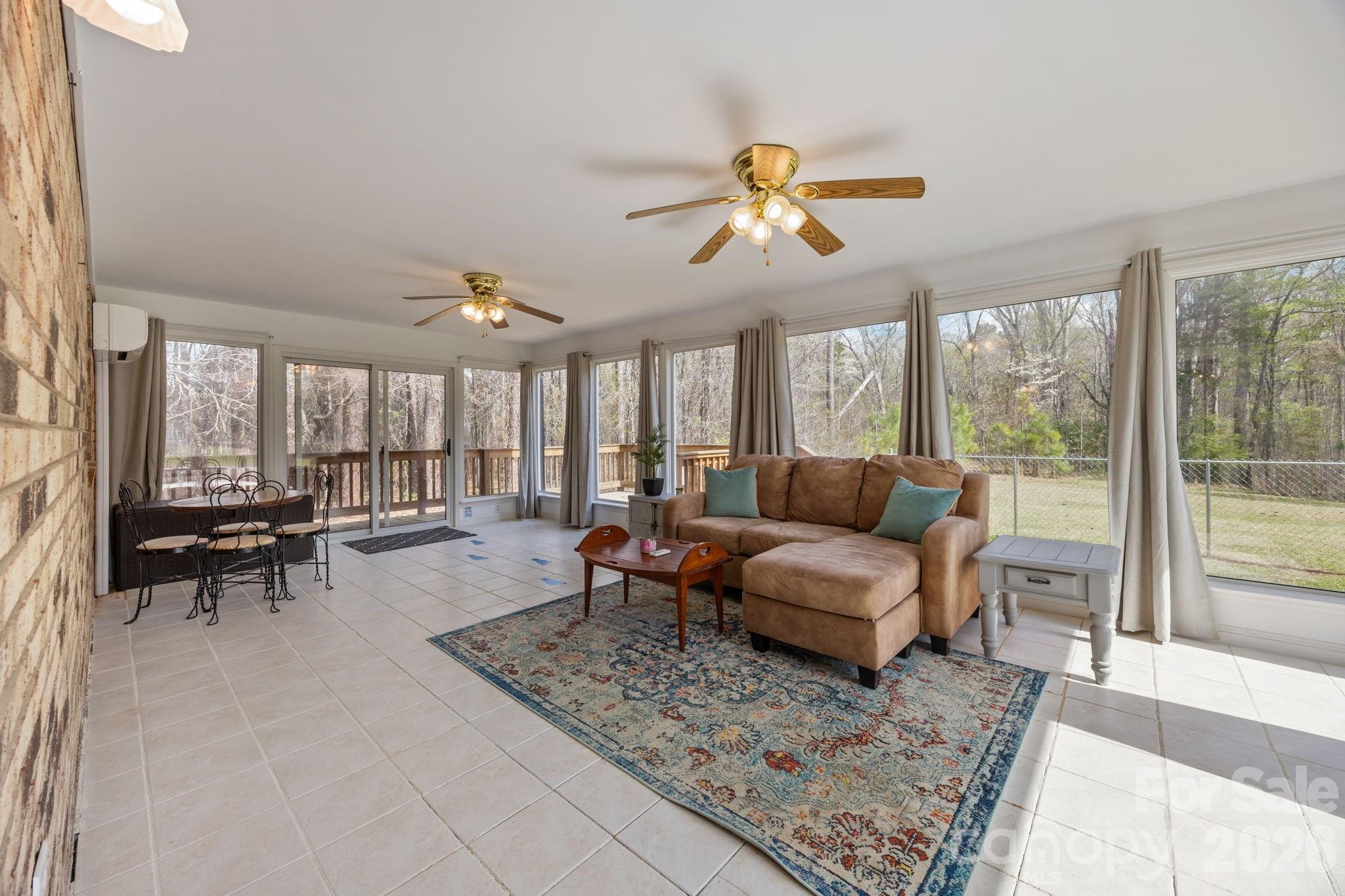 9698 Pine Tree Road, Unit 55 Norwood, NC 28128 - Photo 14 of 29 a living room with furniture and a large window