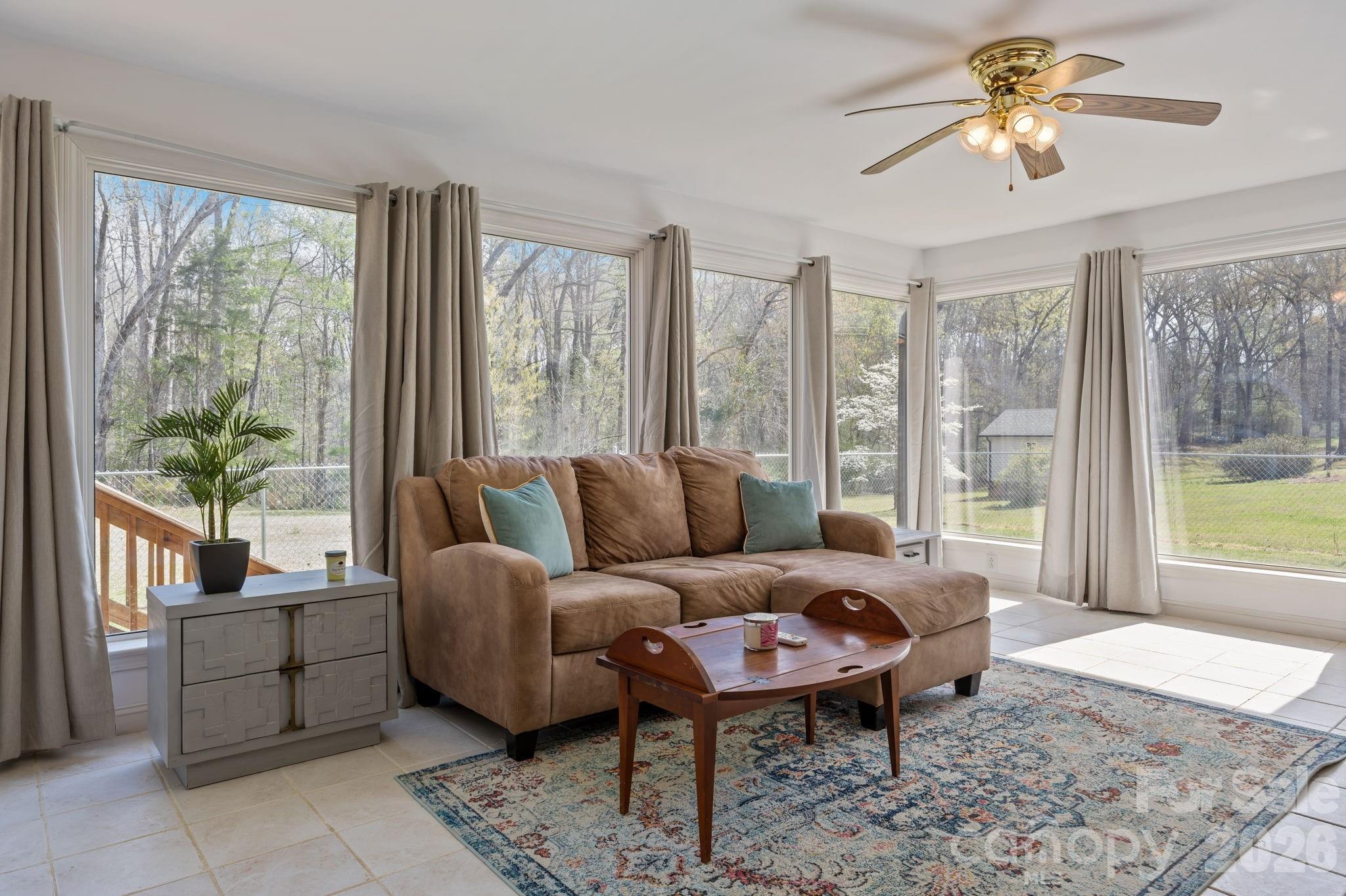 9698 Pine Tree Road, Unit 55 Norwood, NC 28128 - Photo 16 of 29 a living room with furniture and a large window with balcony view
