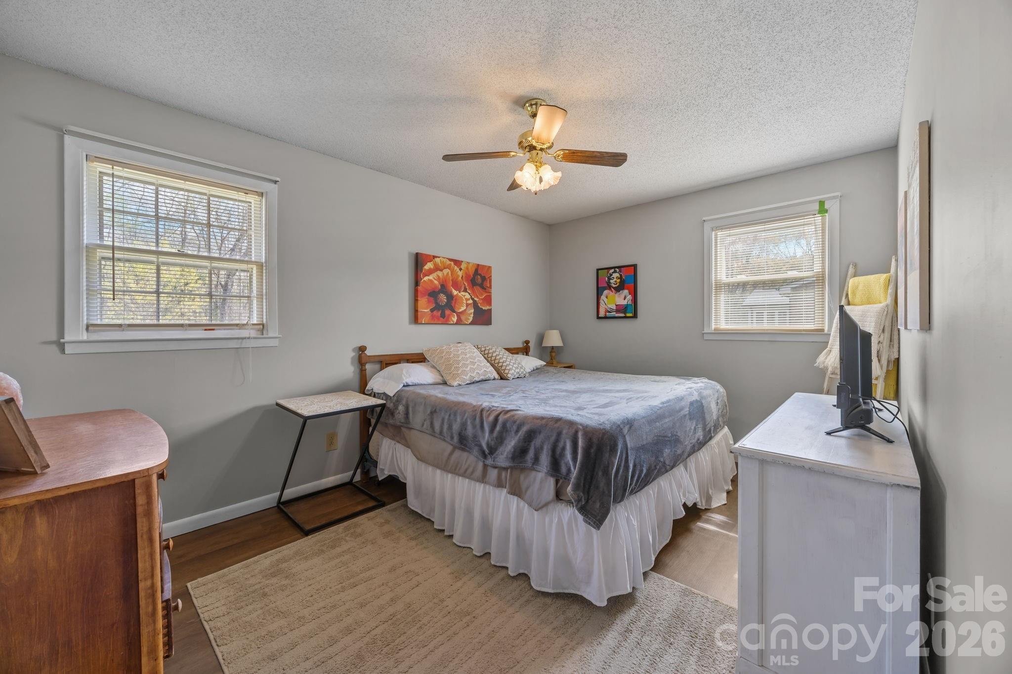 9698 Pine Tree Road, Unit 55 Norwood, NC 28128 - Photo 18 of 29 a bedroom with a bed couch and a window