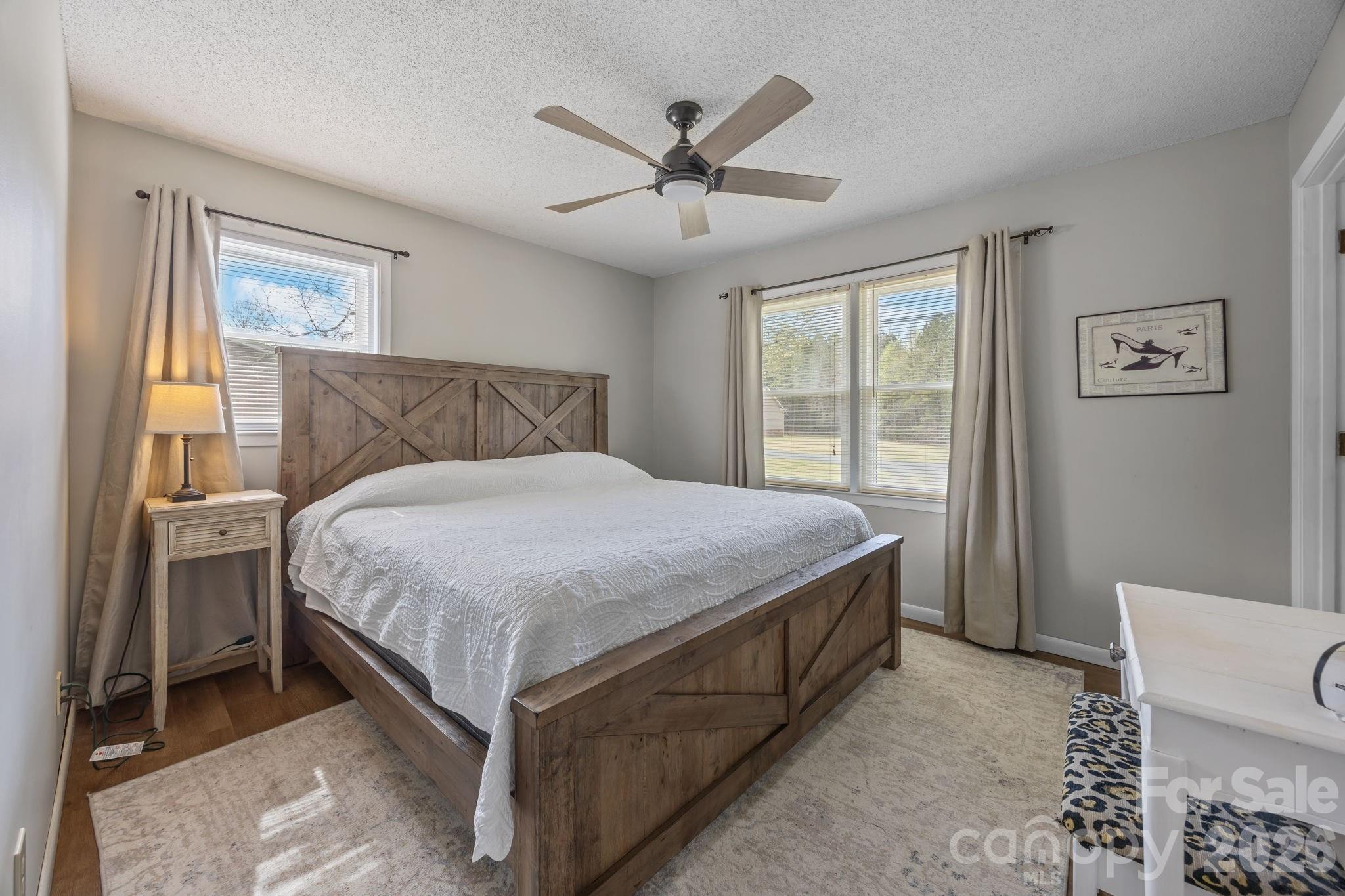 9698 Pine Tree Road, Unit 55 Norwood, NC 28128 - Photo 21 of 29 a bed sitting in a spacious bedroom next to a window