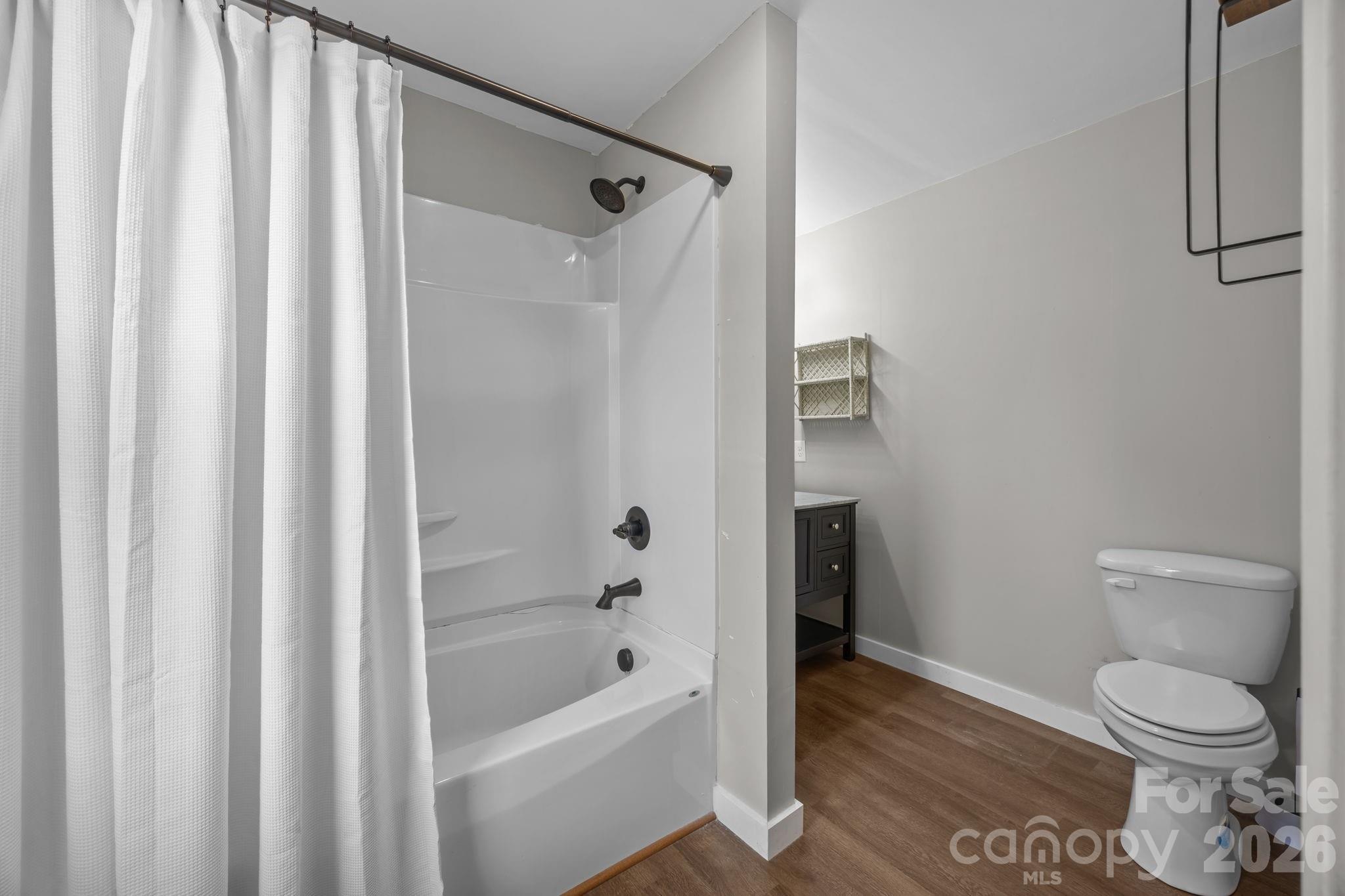 9698 Pine Tree Road, Unit 55 Norwood, NC 28128 - Photo 23 of 29 a bathroom with a toilet and a bathtub