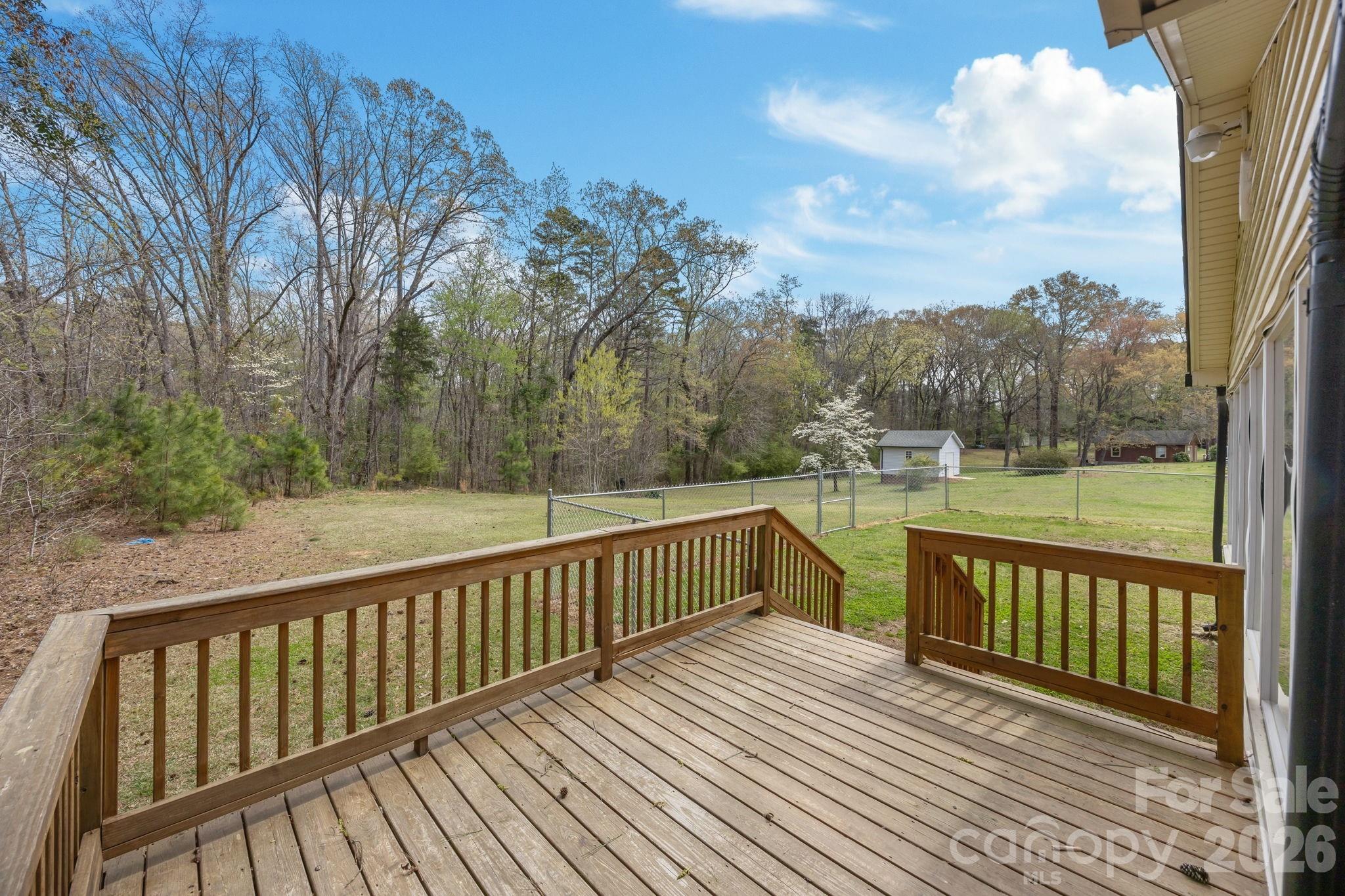 9698 Pine Tree Road, Unit 55 Norwood, NC 28128 - Photo 26 of 29 a view of balcony with wooden floor and fence