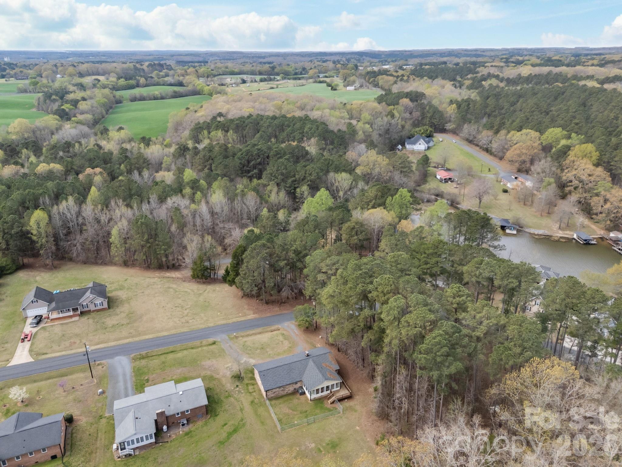9698 Pine Tree Road, Unit 55 Norwood, NC 28128 - Photo 4 of 29 a view of a lake with a mountain in the back