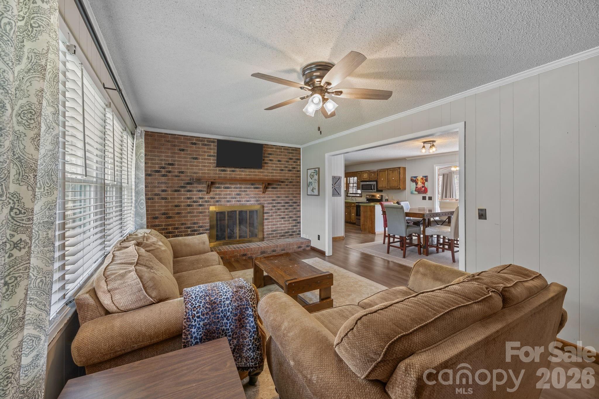 9698 Pine Tree Road, Unit 55 Norwood, NC 28128 - Photo 7 of 29 a living room with furniture and a fireplace