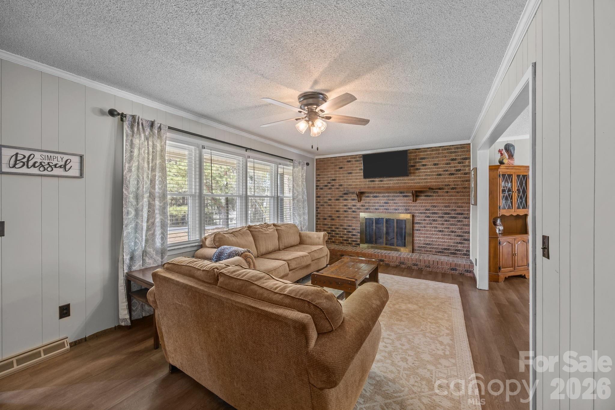 9698 Pine Tree Road, Unit 55 Norwood, NC 28128 - Photo 8 of 29 a living room with furniture and a fireplace
