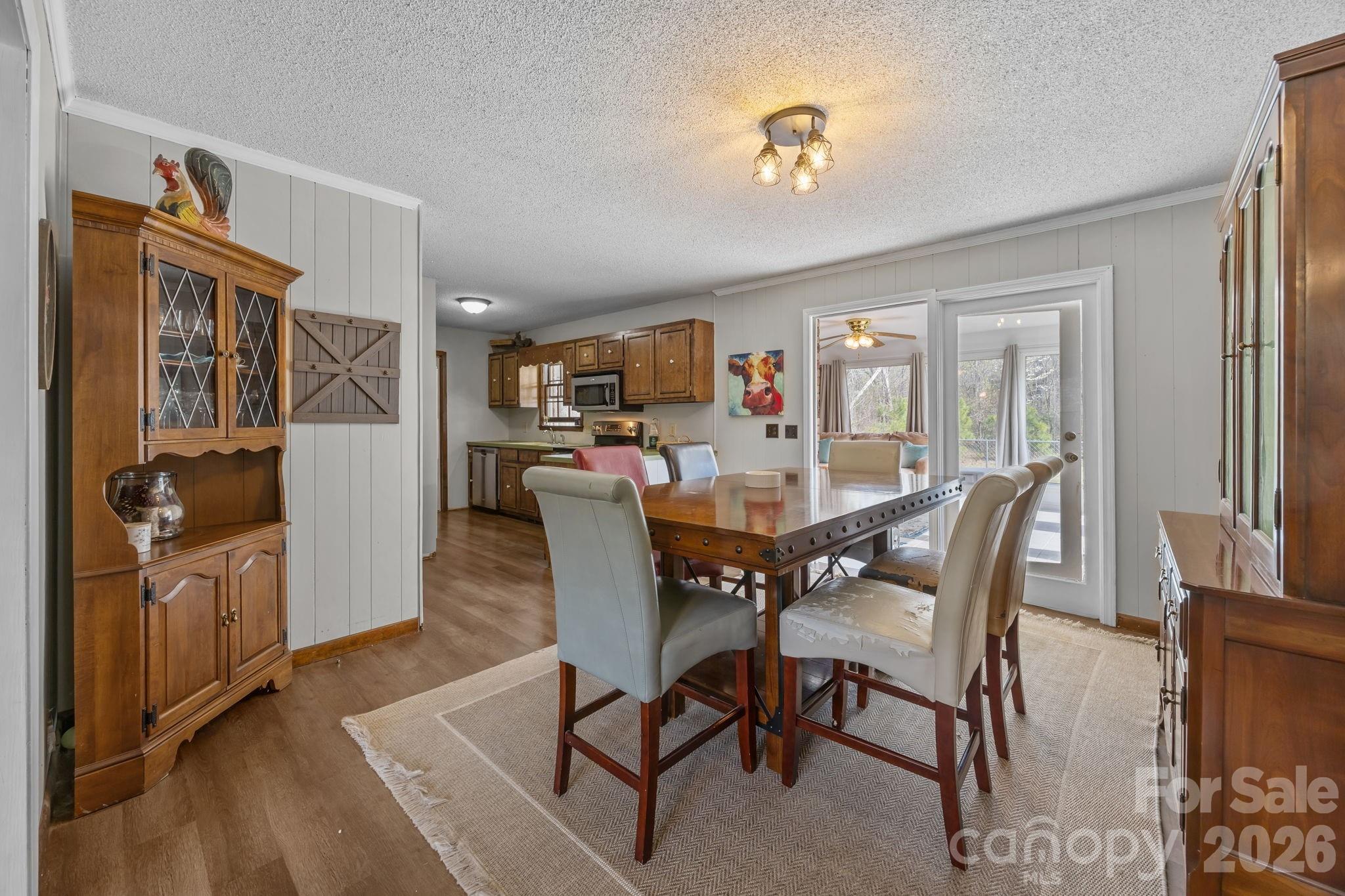 9698 Pine Tree Road, Unit 55 Norwood, NC 28128 - Photo 10 of 29 a view of a dining room with furniture and a chandelier