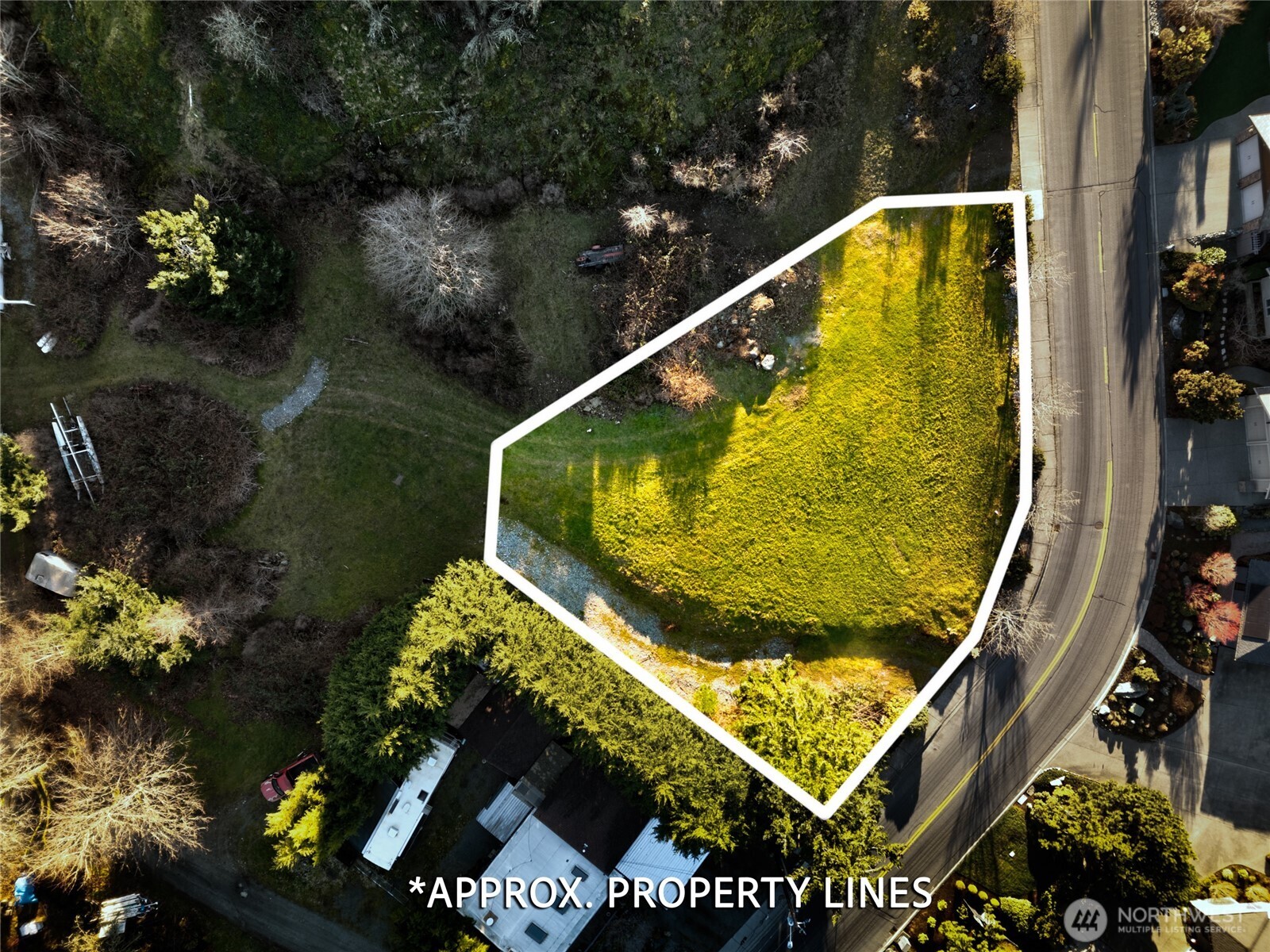 2707 17th Street Anacortes, WA 98221 - Photo 8 of 10 a view of a swimming pool with a yard and potted plants