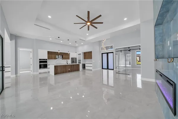 a living room with furniture and kitchen view