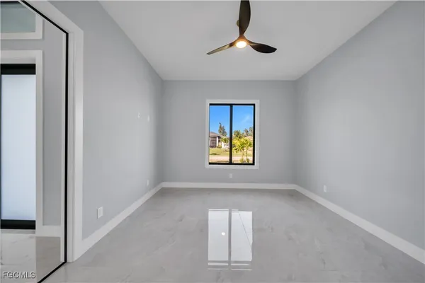 an empty room with windows and painted walls