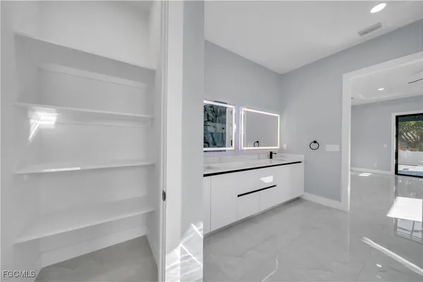 a room with a dresser and mirror