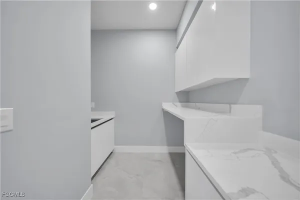 a view of storage and utility room with closet