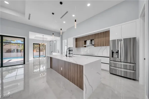 a kitchen with stainless steel appliances a refrigerator and cabinets