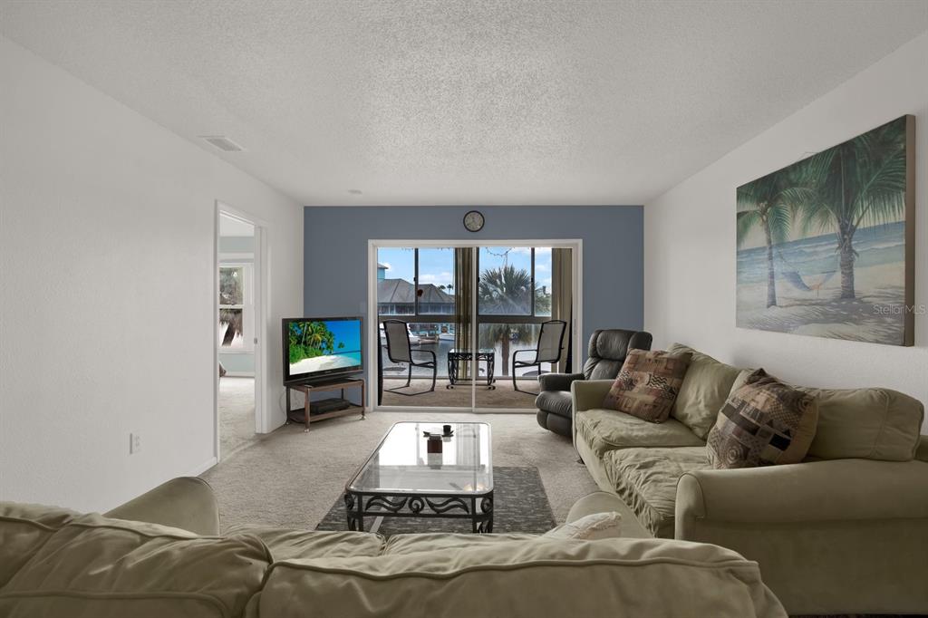4939 Floramar Terrace, Unit 204 New Port Richey, FL 34652 - Photo 11 of 22 a living room with furniture and a large window