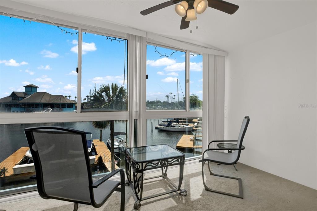 4939 Floramar Terrace, Unit 204 New Port Richey, FL 34652 - Photo 12 of 22 a dining room with furniture and a floor to ceiling window