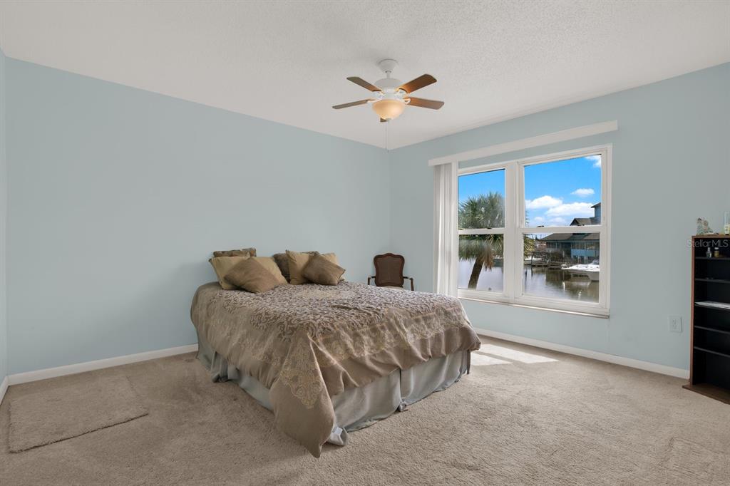 4939 Floramar Terrace, Unit 204 New Port Richey, FL 34652 - Photo 13 of 22 a living room with a bed furniture and a window