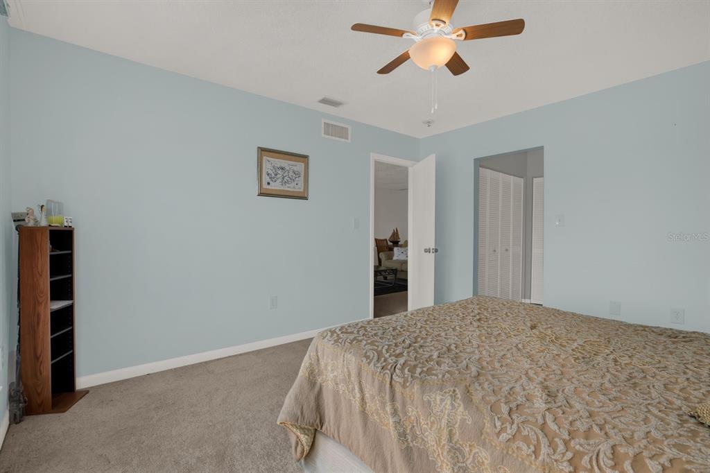 4939 Floramar Terrace, Unit 204 New Port Richey, FL 34652 - Photo 14 of 22 a bedroom with a bed and closet