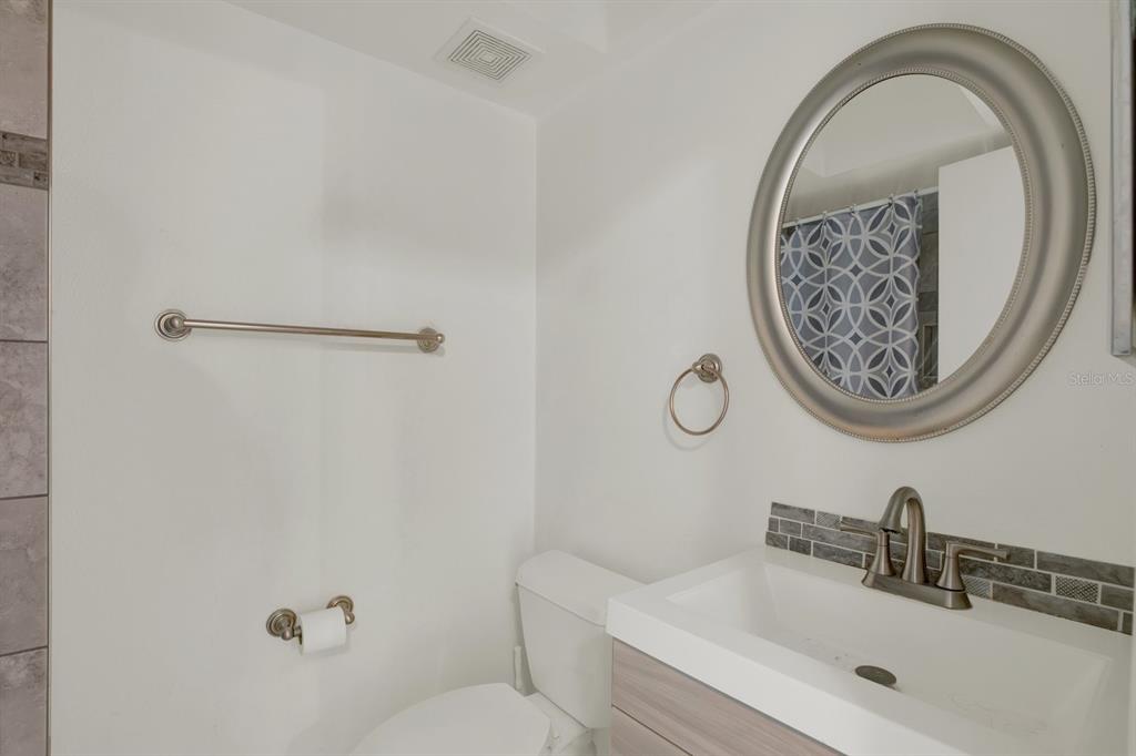 4939 Floramar Terrace, Unit 204 New Port Richey, FL 34652 - Photo 16 of 22 a bathroom with a toilet and a sink