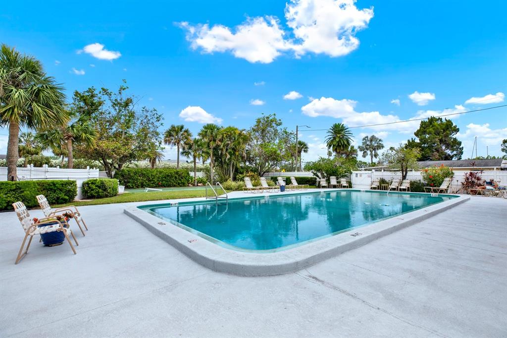 4939 Floramar Terrace, Unit 204 New Port Richey, FL 34652 - Photo 19 of 22 a view of swimming pool with outdoor seating and plants