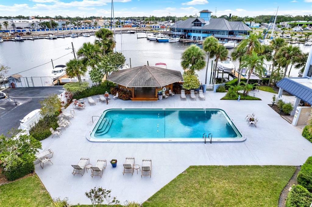 4939 Floramar Terrace, Unit 204 New Port Richey, FL 34652 - Photo 3 of 22 an aerial view of a house having yard