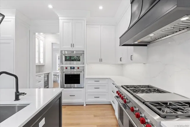 a kitchen with cabinets appliances and a counter space