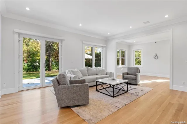 a living room with furniture and large windows