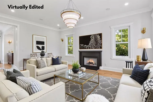 a living room with furniture a fireplace and a large window