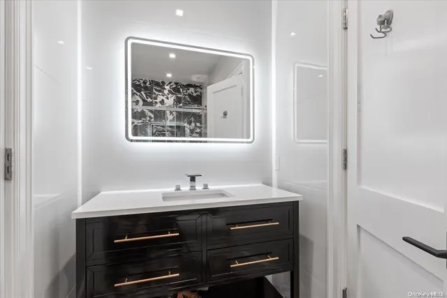 a bathroom with a sink vanity and a mirror