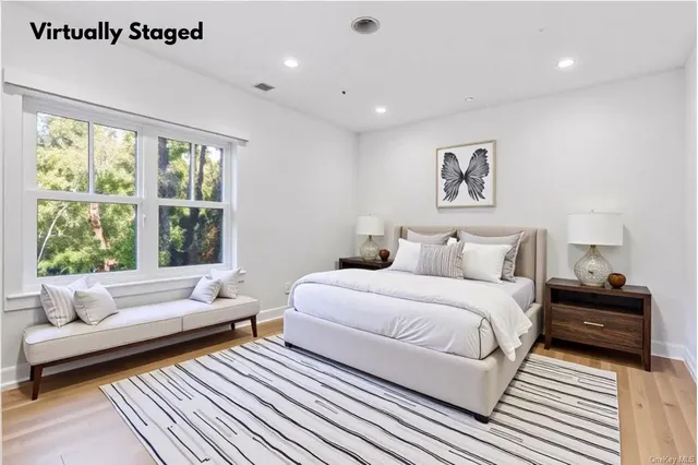 a spacious bedroom with a bed and a couch