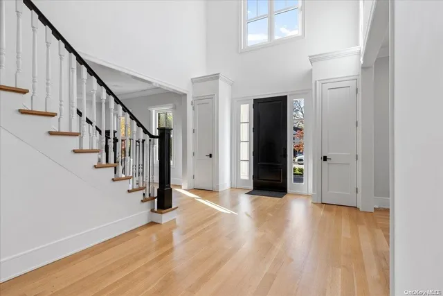 a view of a hallway with wooden floor and staircase