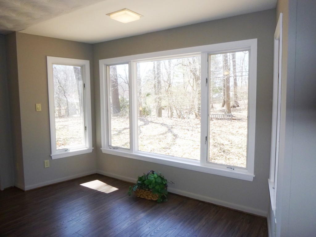 4 Clara Road Framingham, MA 01701 - Photo 3 of 21 a view of an empty room with wooden floor and a window