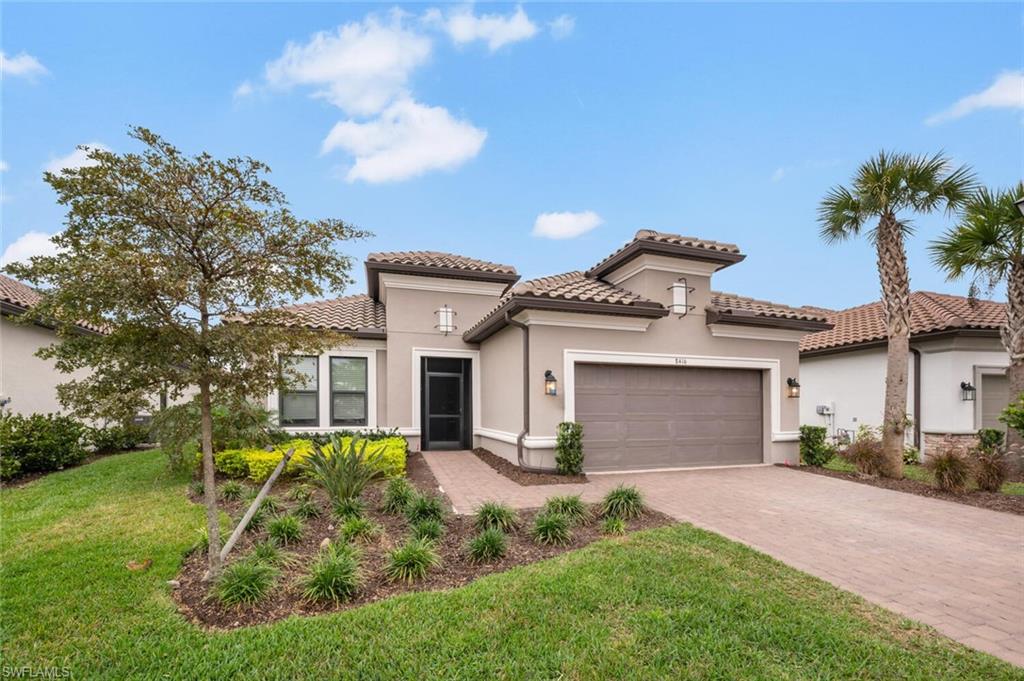 8416 Rosa Court Naples, FL 34114 - Photo 1 of 33 a front view of a house with a yard garage and outdoor seating