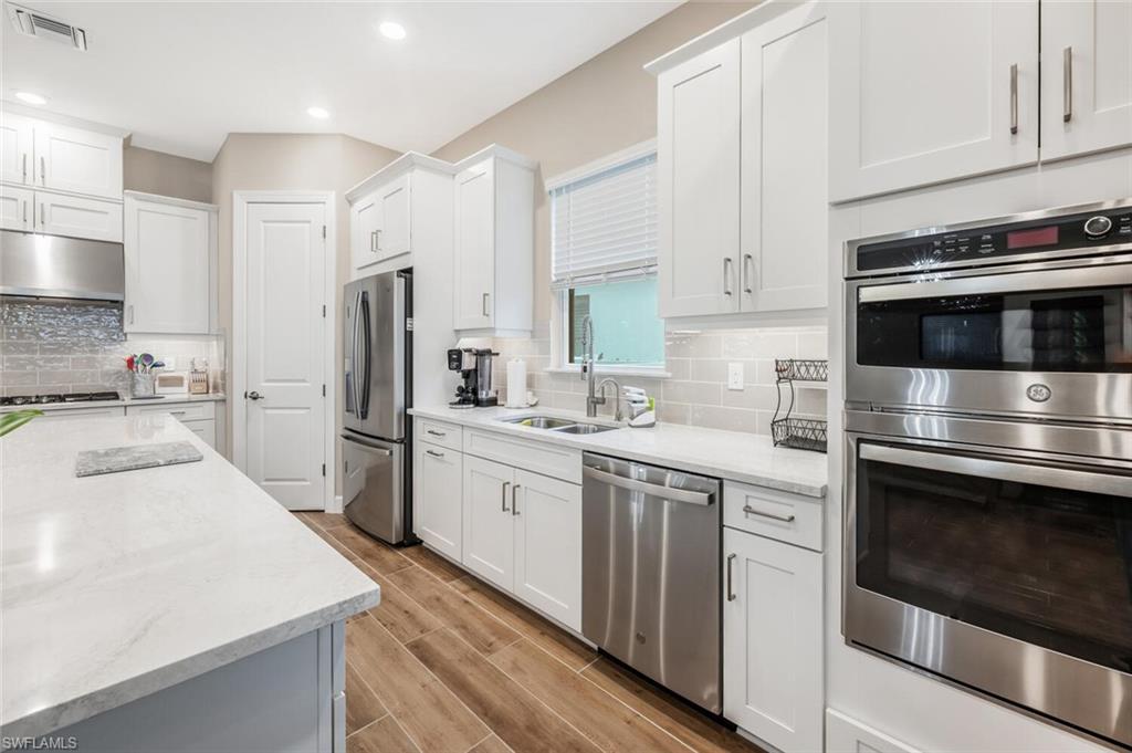 8416 Rosa Court Naples, FL 34114 - Photo 11 of 33 a kitchen with a sink stove and refrigerator