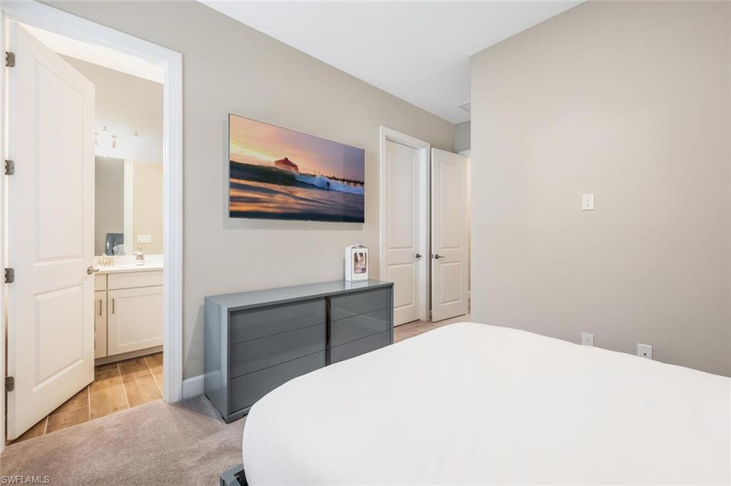 8416 Rosa Court Naples, FL 34114 - Photo 18 of 33 a bedroom with a bed and a flat screen tv