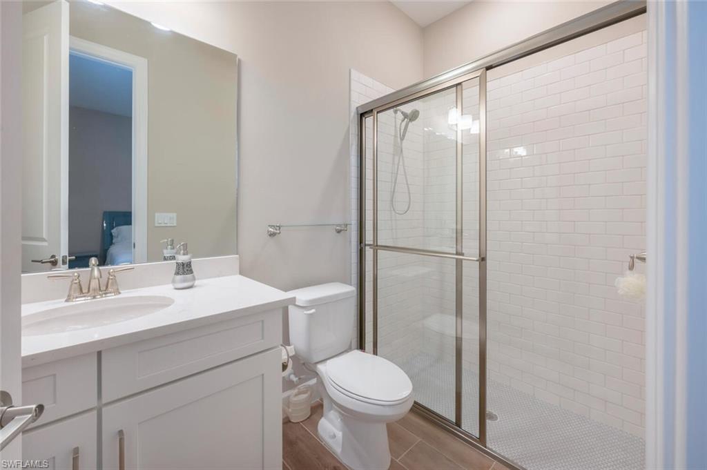 8416 Rosa Court Naples, FL 34114 - Photo 19 of 33 a bathroom with a sink toilet and shower