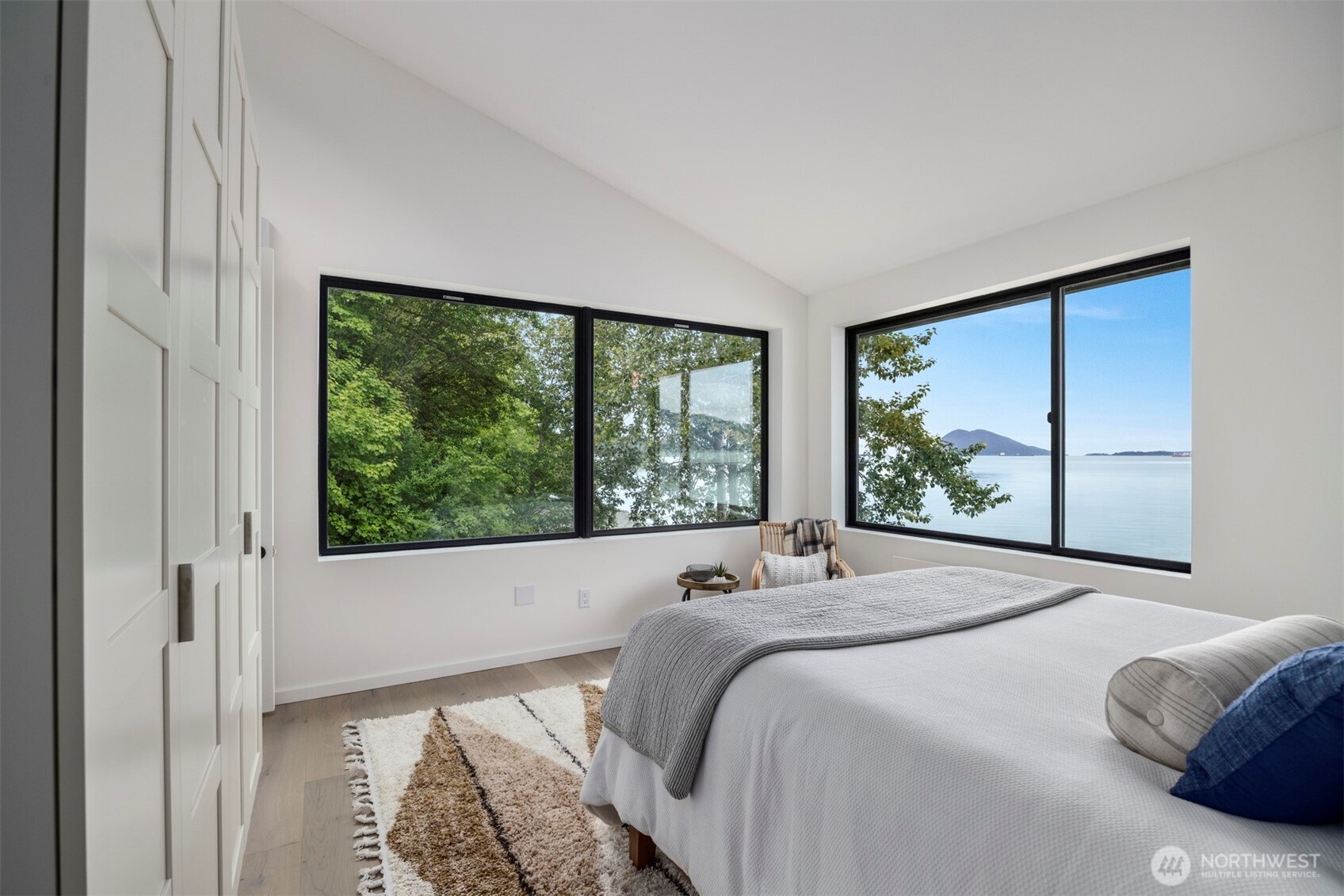 4869 Mercer Road Bow, WA 98232 - Photo 13 of 34 a bed sitting in a bedroom next to a window