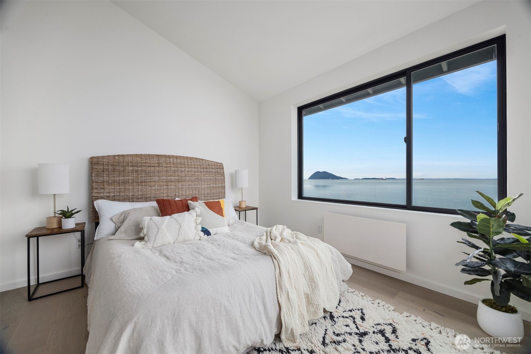 4869 Mercer Road Bow, WA 98232 - Photo 17 of 34 a bedroom with a bed and a potted plant