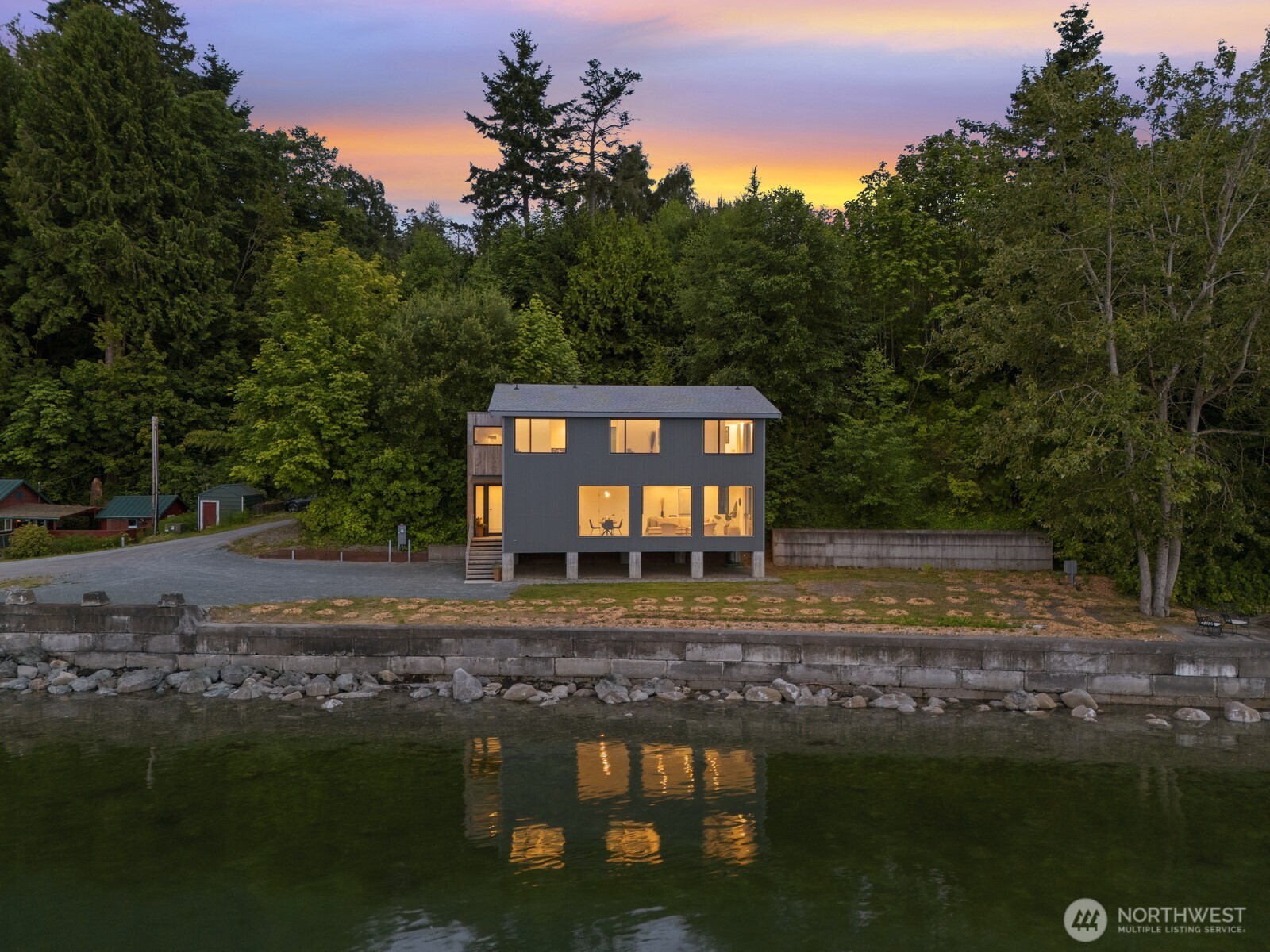 4869 Mercer Road Bow, WA 98232 - Photo 25 of 34 a view of a brick house next to a yard with large trees
