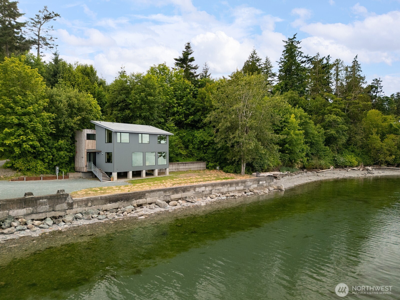 4869 Mercer Road Bow, WA 98232 - Photo 4 of 34 a house with river in front of it