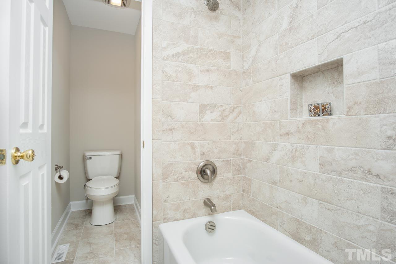807 Colonial Drive Raleigh, NC 27603 - Photo 22 of 25 a bathroom with a toilet and a bathtub