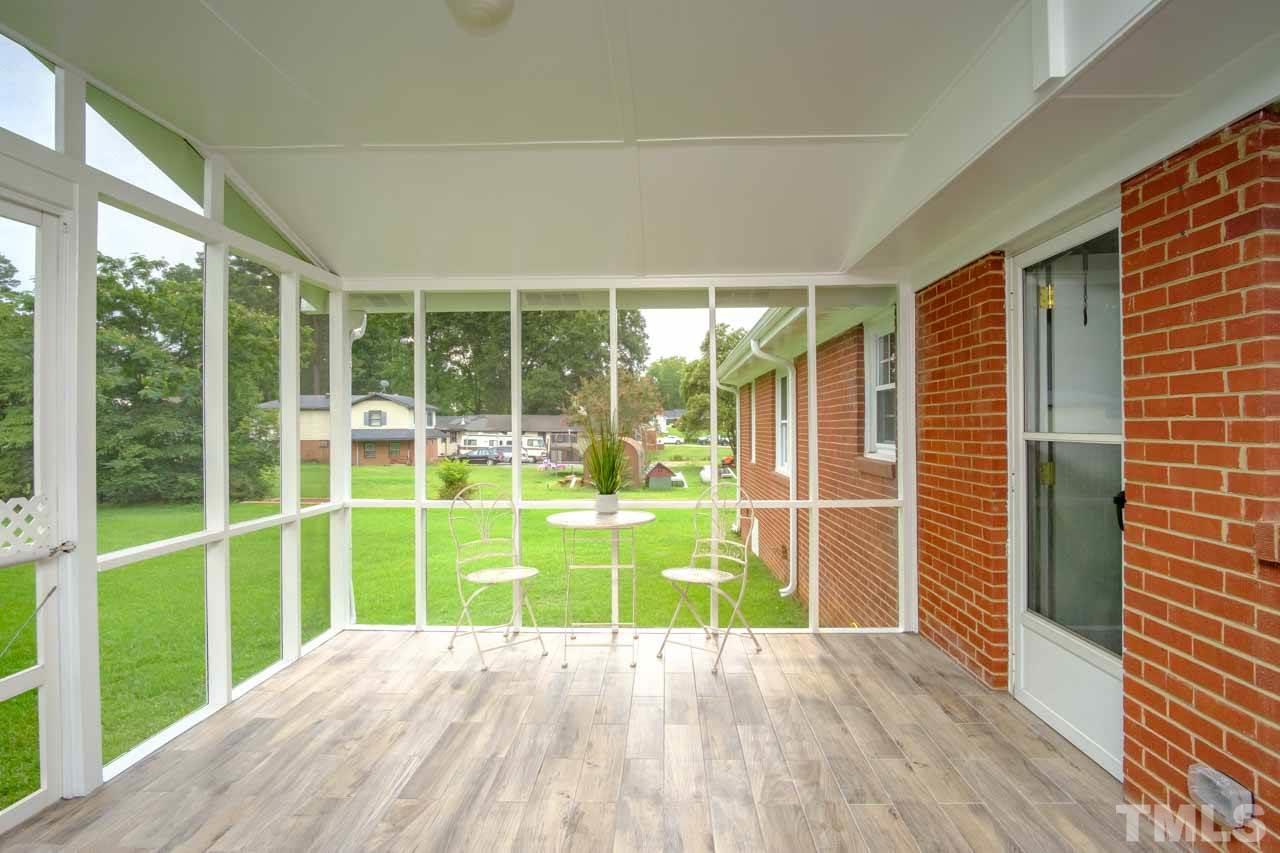 807 Colonial Drive Raleigh, NC 27603 - Photo 5 of 25 a view of an empty room with wooden floor and a yard