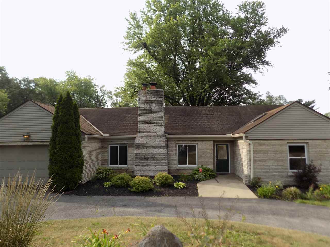 4315 Spring Creek Road Rockford, IL 61107 - Photo 1 of 39 a front view of a house with a garden and yard