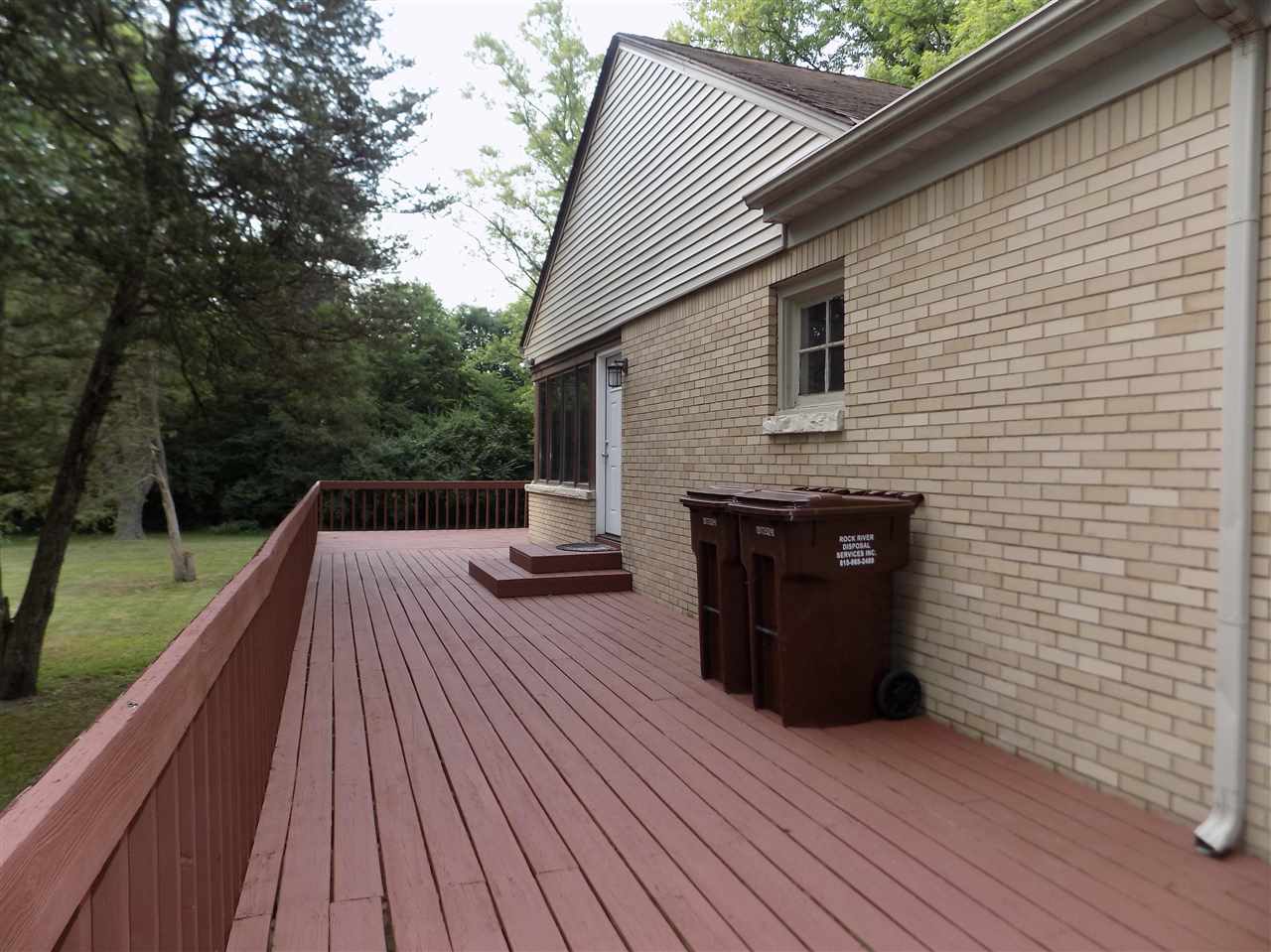 4315 Spring Creek Road Rockford, IL 61107 - Photo 35 of 39 a view of backyard with a deck and wooden floor