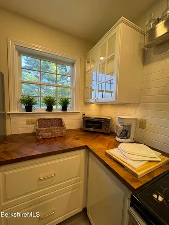 a kitchen with stainless steel appliances granite countertop a sink and stove top oven