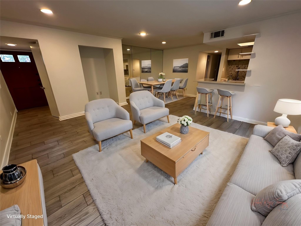 a living room with furniture rug and window